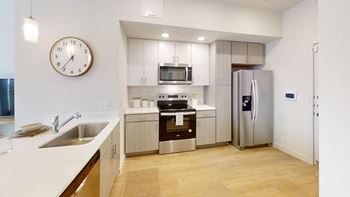 Modern kitchen with stainless steel appliances and white countertops